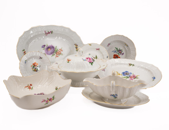 A large bowl with bird decor and flowers
